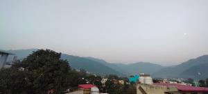 a view of a city with mountains in the background at Hotel Gloria Rishikesh in Rishīkesh +15 photos