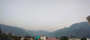 a view of a city with mountains in the background at Hotel Gloria Rishikesh in Rishīkesh