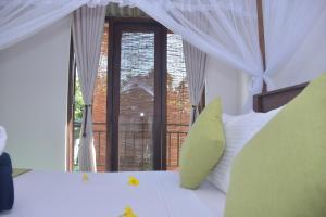 a bedroom with a bed with a large window at Coco Villa Udawalawe in Udawalawe