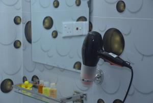a blow dryer in front of a mirror at Coco Villa Udawalawe in Udawalawe