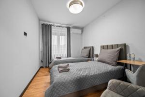 En eller flere senge i et værelse på Centrum Prime Apartments