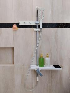 a shower with a blow dryer in a bathroom at RADJIMIN Guesthouse in Adi Sutjipto +54 photos