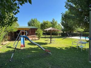 a playground in a yard with a slide at Guathemoc cabañas in Panaholma