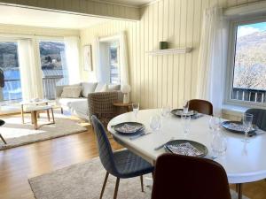 a living room with a white table and chairs at A pearl in Lofoten in Leknes
