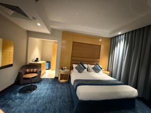 En eller flere senge i et værelse på Blue Rose Garden Hotel فندق بلو روز جاردن العليا