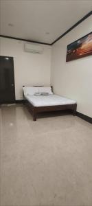 a bedroom with a bed and a tv in a room at CocoVille Guesthouse Couple Room in Alegria
