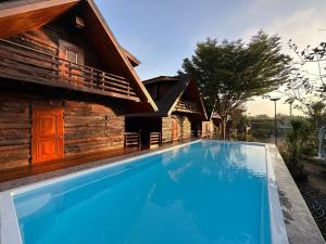een zwembad voor een huis bij พิมพ์วนา เขาใหญ่ in Nakhon Ratchasima