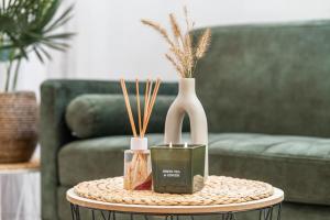 a table with two vases and a couch at dreamfactory Residence - Eastside in Vienna