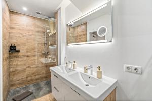 a white bathroom with a sink and a shower at dreamfactory Residence - Eastside in Vienna