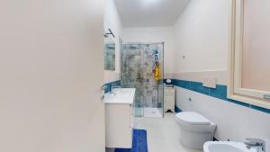 a bathroom with a toilet and a sink and a shower at LucevanLeStelle - Full Comfort Quiet Apartment by the Promenade in Viareggio +12 photos