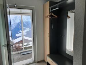 a bathroom with a window and a view of a mountain at Tamara Parterre in Riederalp