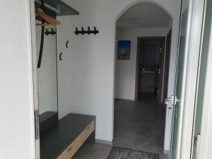 a room with a hallway with a counter and a mirror at Tamara Parterre in Riederalp