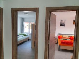 a bedroom with a bed and a door leading into a room at Tamara Parterre in Riederalp +11 photos