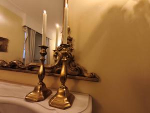 a bathroom with two candles on top of a toilet at Chateau Suites - Schloss Malberg in Malberg