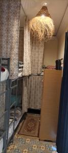 a room with a closet with a curtain and a chandelier at Hostel Laksour in Marrakesh +76 photos