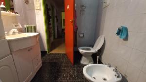 a small bathroom with a toilet and a sink at La casa de los titiriteros in Mina Clavero +9 photos