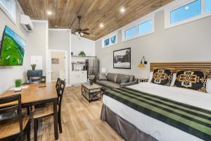 a bedroom with a bed and a desk and a couch at Carolina Camp Cedar in Pickens