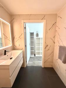 a bathroom with a sink and a mirror at Vila Pombal Tomar Apartments - Pool & City Views in Tomar