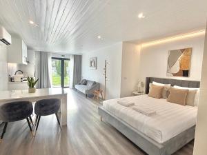 a bedroom with a bed and a table and chairs at Vila Pombal Tomar Apartments - Pool & City Views in Tomar +78 photos