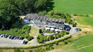 an aerial view of a large house with a parking lot at Schnütgenhof Übernachtung am Biggesee in Attendorn