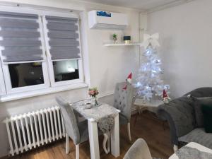 a living room with a christmas tree and a table at Apartman Dacha, Centar Ilidže, Ustanička broj 23 in Sarajevo