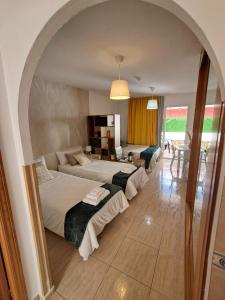 a bedroom with two beds and a living room at Apartamento ELIDE in Costa Del Silencio +19 photos