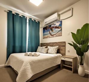 a bedroom with a large bed with blue curtains at Hotel Birillo in La Spezia