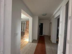 an empty hallway with white walls and wood floors at Cheita 305 in Cheia