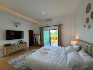 Postel nebo postele na pokoji v ubytování มานอนปัว โฮมสเตย์ น่าน Manornpua Homestay Nan + 5 fotografií