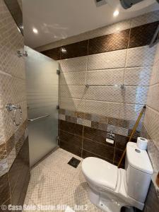 a bathroom with a toilet and a shower at Casa Sole Sharm Hills Apt 2 in Sharm El Sheikh +7 photos