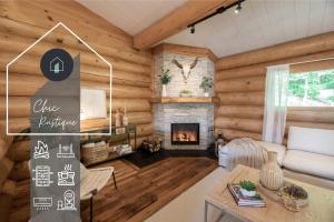 a living room with wooden walls and a fireplace at Chalet Chic Rustique & SPA - Tremblant in Lac-Superieur +37 photos