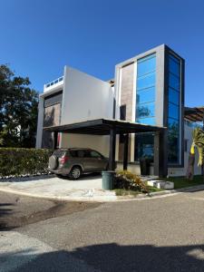 een auto geparkeerd op een parkeerplaats voor een gebouw bij Caribbean getaway Villa 30 in Puerto Plata