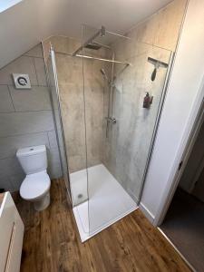 a bathroom with a shower with a toilet at Hygge Homes - Modern 1 bed house in Lincoln +17 photos