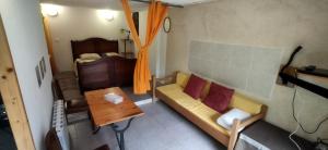 a living room with a couch and a bed at Studio La Cheneraie in Bargemon
