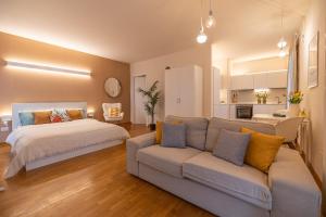 a living room with a bed and a couch at ComfortHouse la tua estate in Ravenna +43 photos