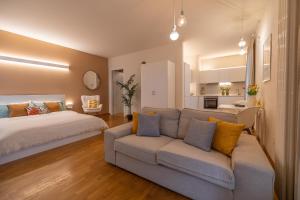 a living room with a bed and a couch at ComfortHouse la tua estate in Ravenna