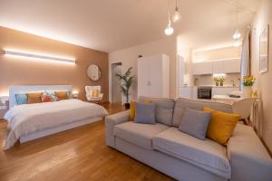 a living room with a bed and a couch at ComfortHouse la tua estate in Ravenna