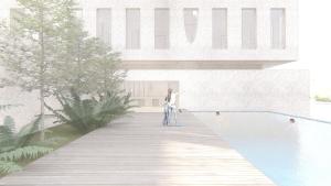 een vrouw staat op een promenade naast een zwembad bij ARTOTEL Leguna Magelang in Magelang