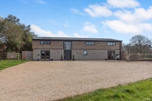 a large barn with a gravel driveway in front of it at Pine Ridge 1 in Bristol +5 photos