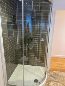 a shower with a glass door in a room at Pine Ridge 1 in Bristol