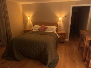 a bedroom with a bed with two night stands and two lamps at Pine Ridge 1 in Bristol