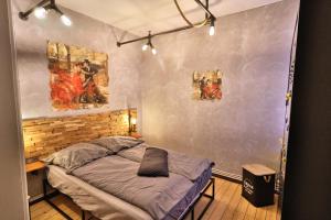 a room with a bed and two paintings on the wall at Altstadtblick Altenburg in Altenburg