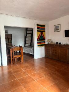 a room with a bedroom with a table and a bed at Flor de Lis Casa in La Paloma