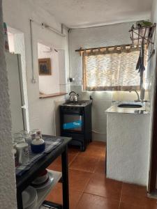 a small kitchen with a sink and a stove at Flor de Lis Casa in La Paloma
