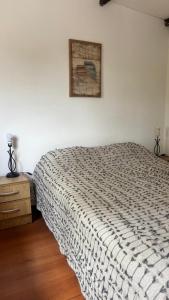 a bedroom with a bed and a picture on the wall at Flor de Lis Casa in La Paloma