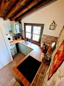 a kitchen with a counter and a sink and a refrigerator at Torre del Tempo in Torgiano +24 photos