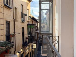 una vista di un vicolo con un orologio su un edificio di Smartmonki Sinagoga Entre la Catedral y Zocodover a Toledo