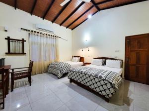 Postel nebo postele na pokoji v ubytování MG Resort - Yala