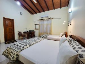 Postel nebo postele na pokoji v ubytování MG Resort - Yala