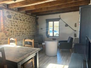 a room with a table and chairs and a window at Maison typique Auvergne in Montel-de-Gelat
